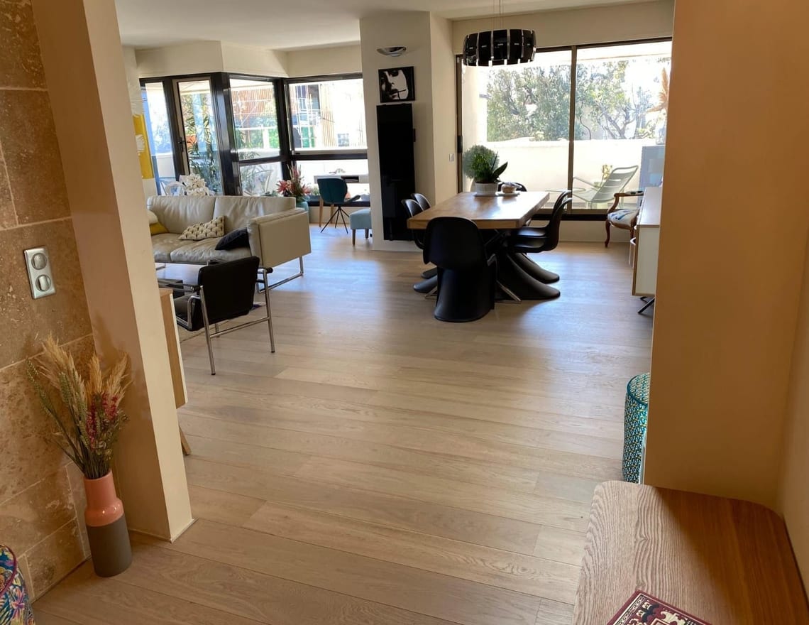 Séjour et salle à manger d'appartement rénové avec parquet chêne clair