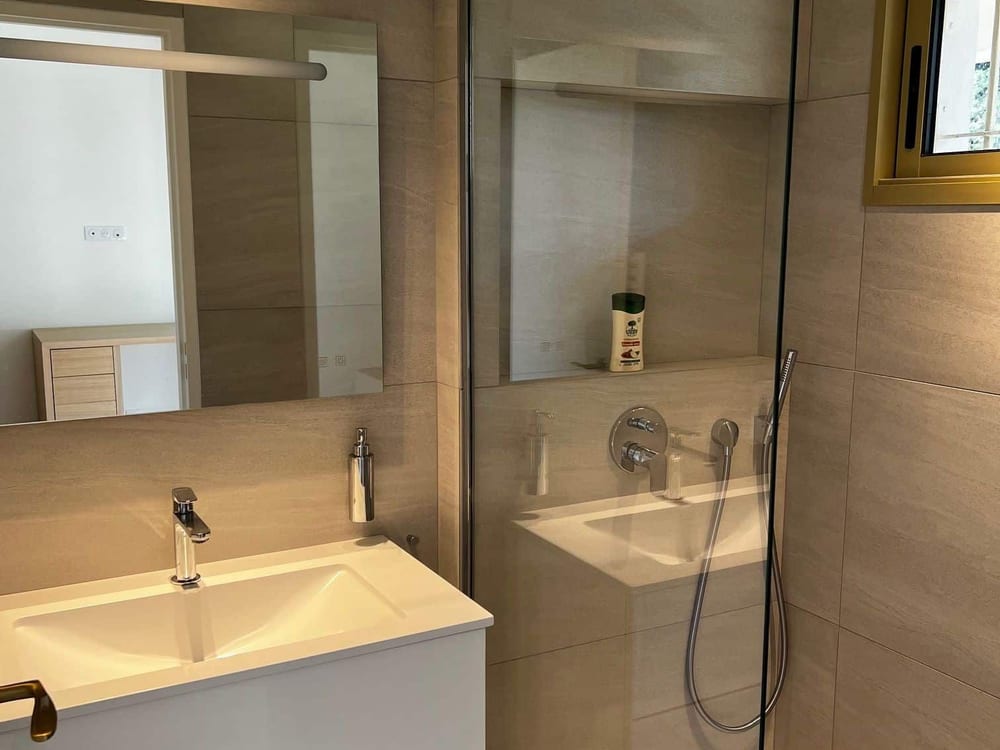 Salle de bains rénovée avec douche à l'italienne et meuble suspendu